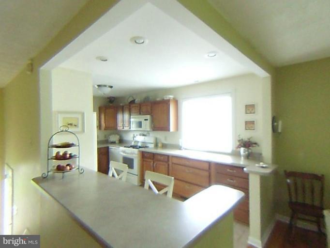 9219 Sandra Park Road Perry Hall, MD 21128 - Photo 9 of 11 a kitchen with a sink a counter top space and living room