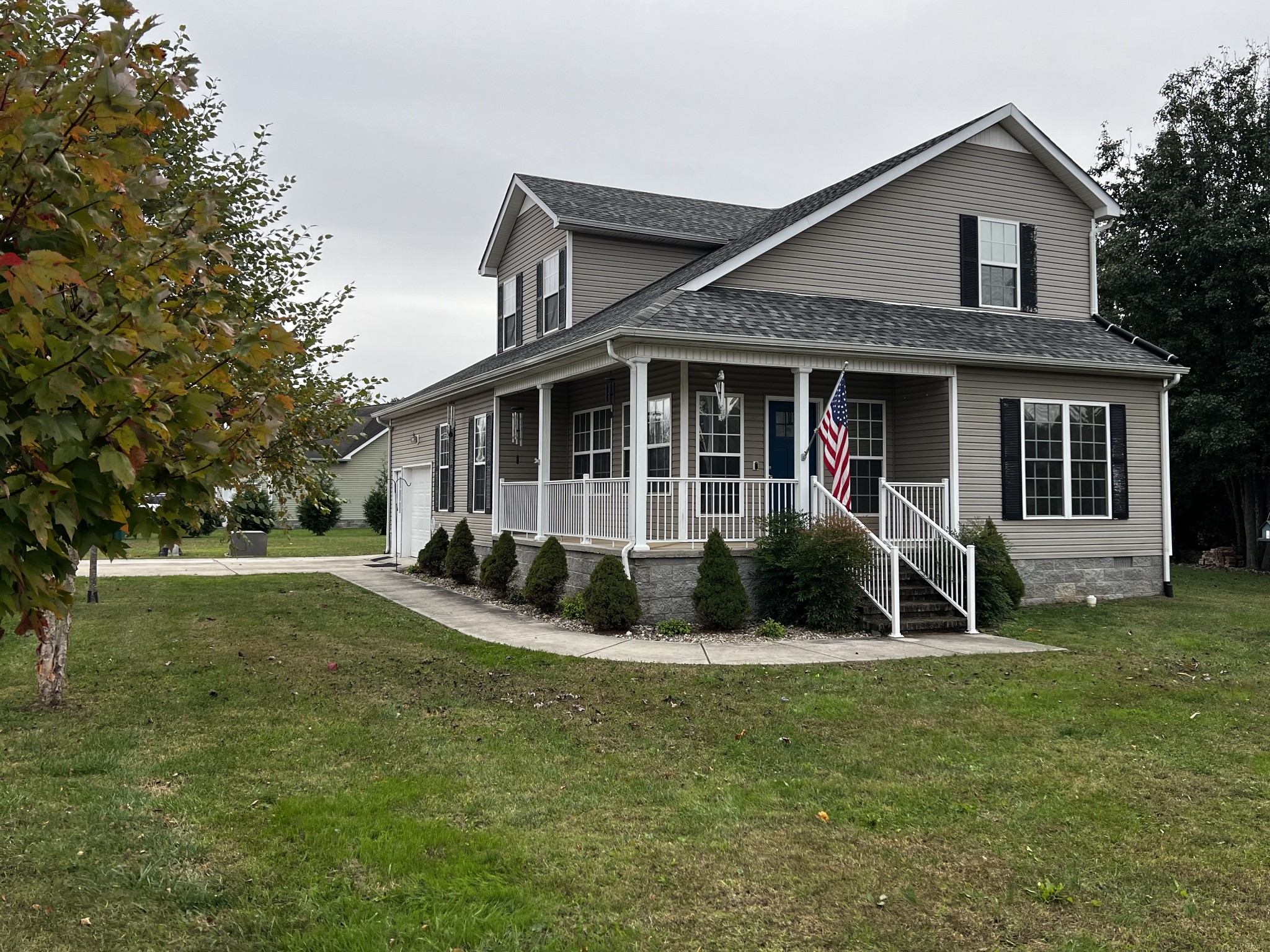 a view of a house with a yard porch and sitting area