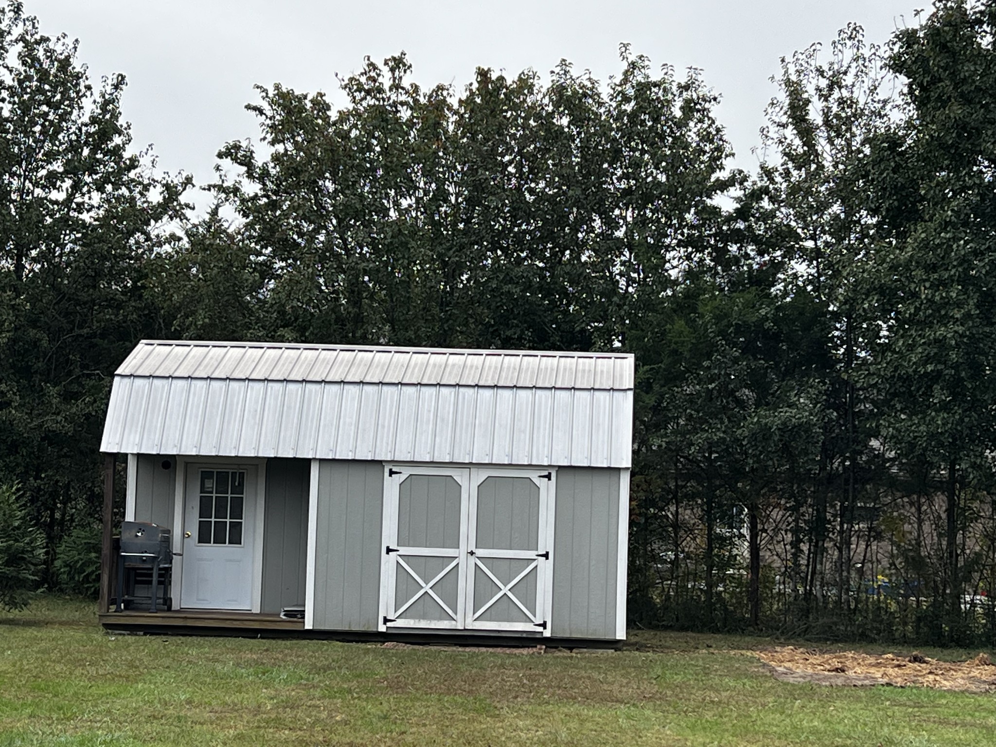 305 Duncan Lane Winchester, TN 37398 - Photo 5 of 34 a view of a kitchen with a sink and dishwasher with wooden floor and yard in the back