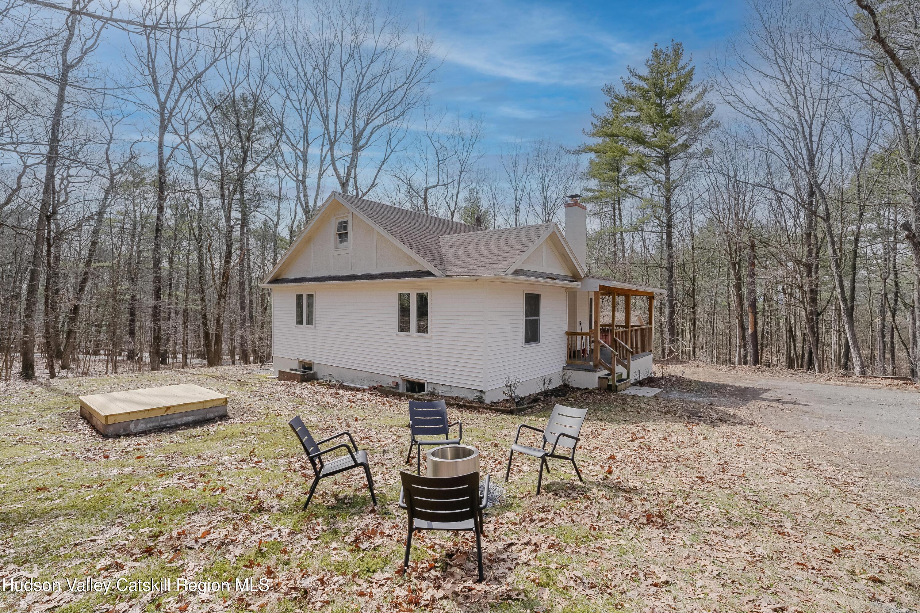 230 Potic Mountain Road Athens, NY 12414 - Photo 3 of 25 a view of a house with backyard and sitting area