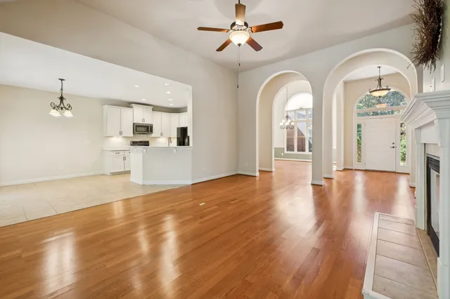 a kitchen with granite countertop a stove a sink and a microwave