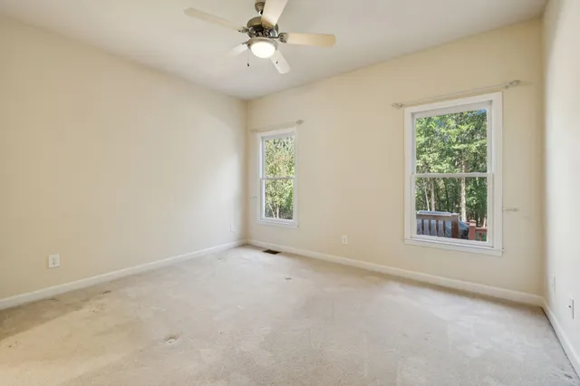 an empty room with a empty space and windows