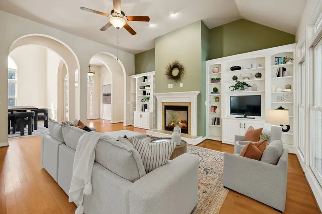 a view of empty room with wooden floor and fireplace