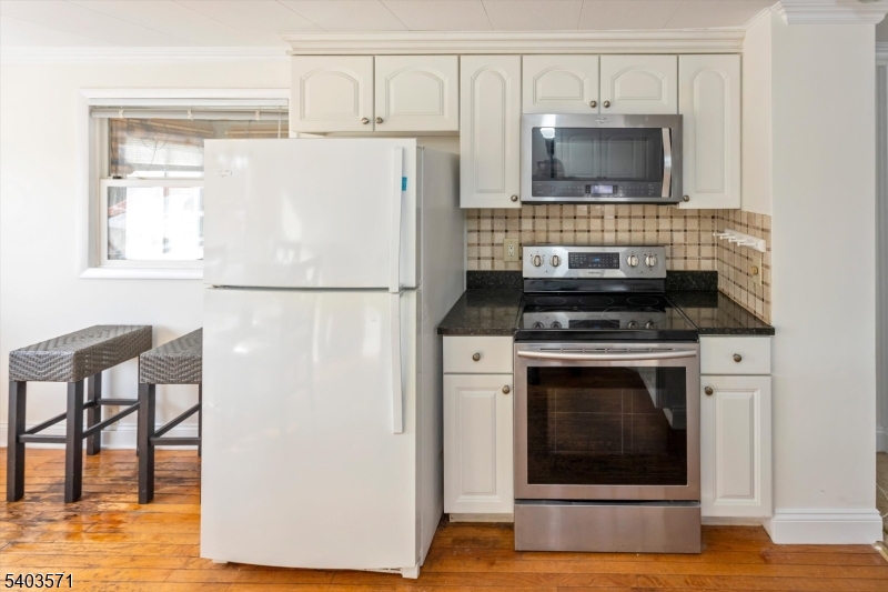 195 West Main Street, Unit G Chester, NJ 07930 - Photo 12 of 23 a kitchen with a refrigerator stove and microwave