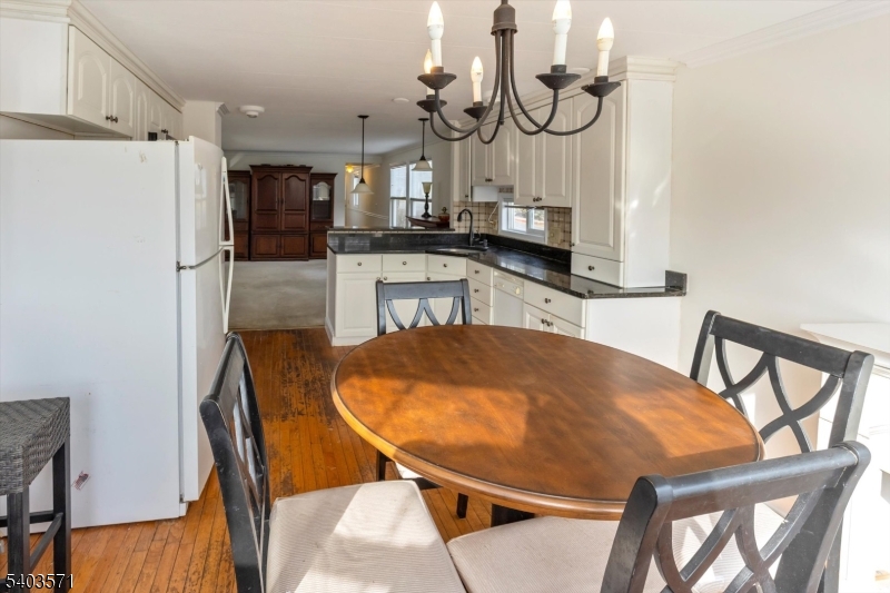 195 West Main Street, Unit G Chester, NJ 07930 - Photo 14 of 23 a view of a dining room with furniture and wooden floor