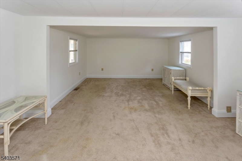 195 West Main Street, Unit G Chester, NJ 07930 - Photo 15 of 23 an empty room with a bench and windows