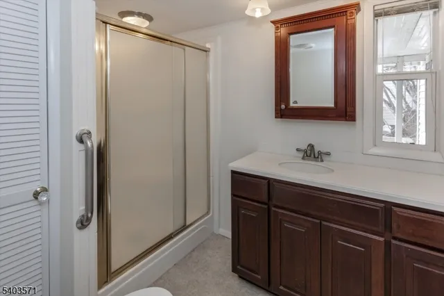 a bathroom with a sink a mirror and a bath tub