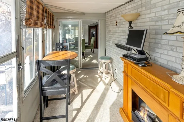 a dining room with furniture and a floor to ceiling window