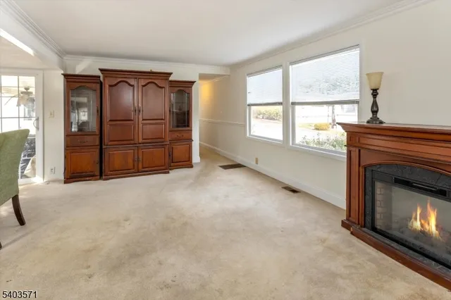 an empty room with windows and fireplace