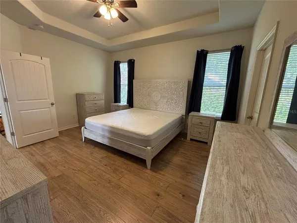 a bedroom with a bed and a chandelier
