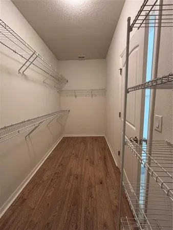 a view of a room with wooden floor and white walls