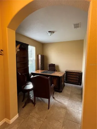 a bedroom with a bed and a desk