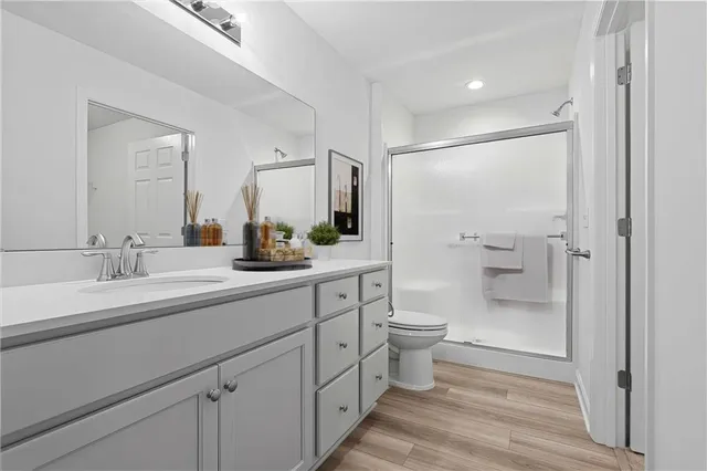 a bathroom with a sink a toilet a shower and a mirror