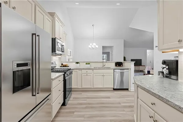 a kitchen with a sink refrigerator and cabinets