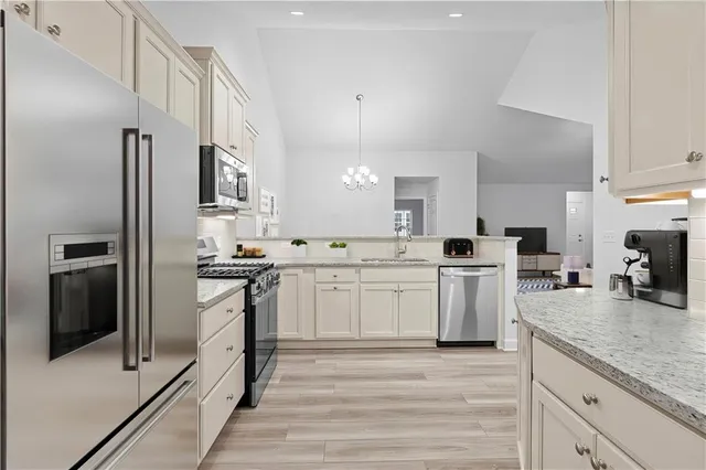 a kitchen with a sink refrigerator and cabinets