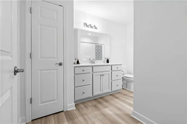 a room with white cabinets and sink