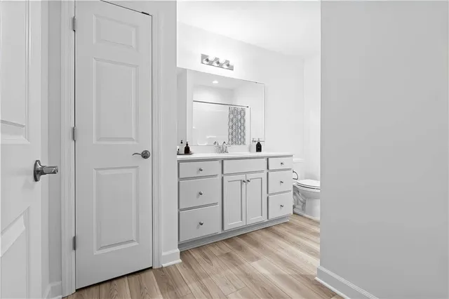 a room with white cabinets and sink