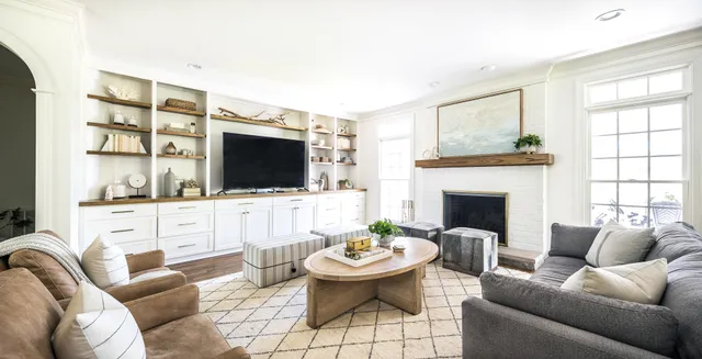 a kitchen with kitchen island granite countertop a sink appliances cabinets and a large window