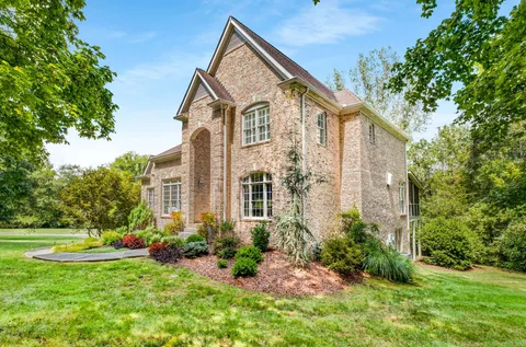 a view of a house with backyard and garden
