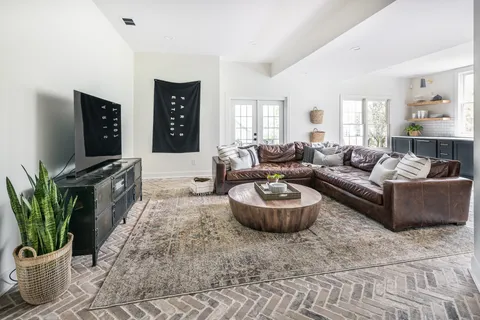 a backyard of a house with a table and chairs