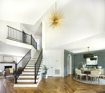 a view of a livingroom with furniture and staircase