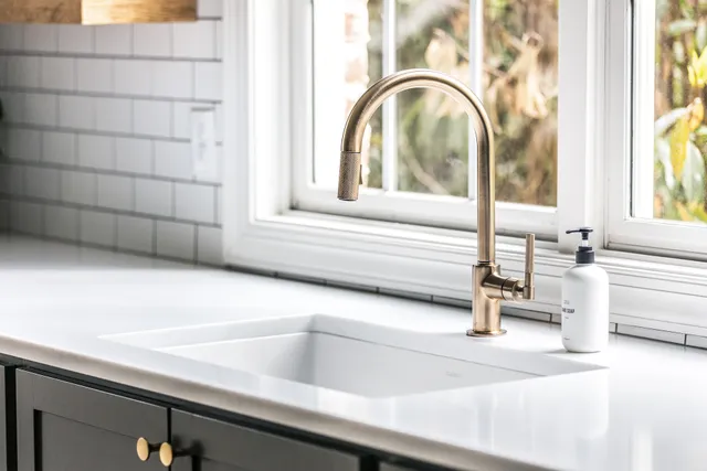 a view of a green field with trees in the background