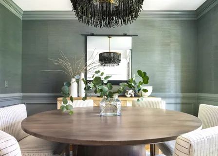 a dining room with furniture and a potted plant