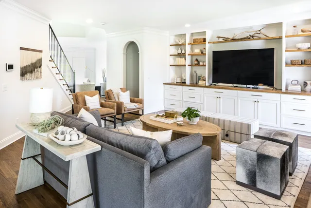 a living room with a fireplace and large windows