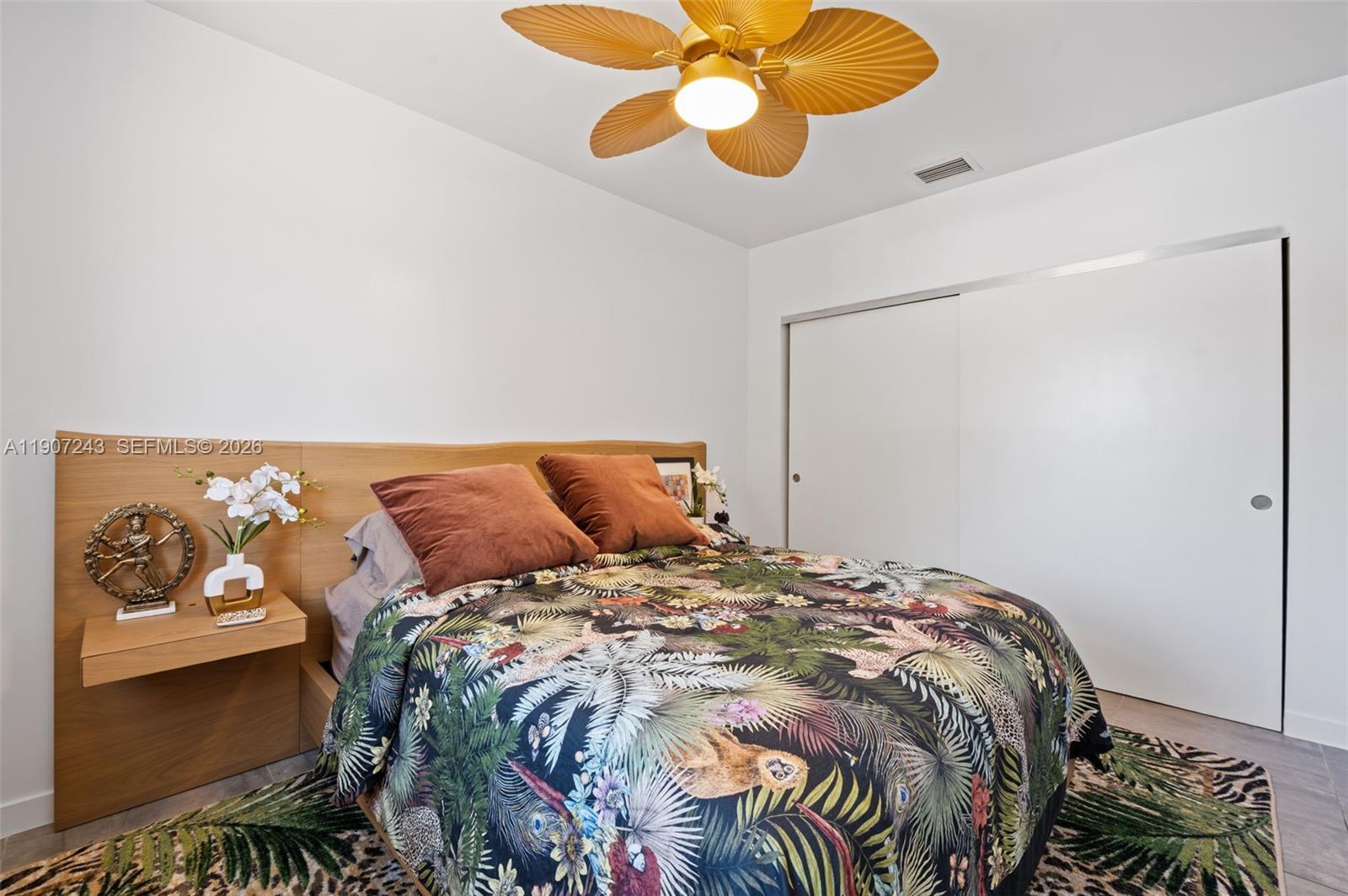 165 Northwest 39th Street, Unit 7 Miami, FL 33127 - Photo 11 of 19 a bed sitting in a bedroom next to a window