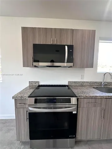 a kitchen with a stove and a microwave