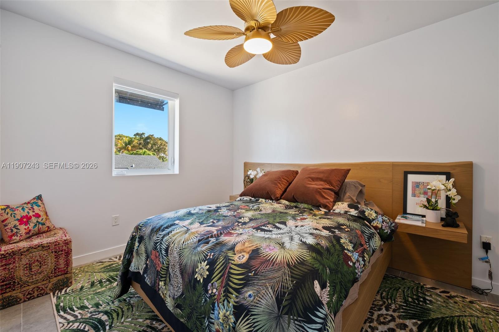 165 Northwest 39th Street, Unit 7 Miami, FL 33127 - Photo 10 of 19 a bedroom with a bed and painting on the wall