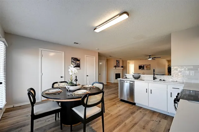 a kitchen with a dining table chairs and stove