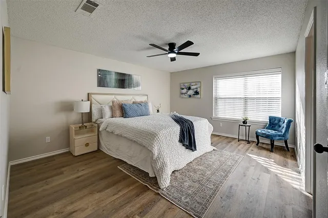 a bedroom with a large bed and a window