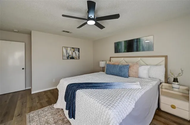 a bedroom with a bed and ceiling fan
