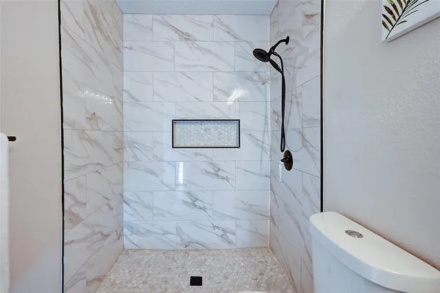 a bathroom with a toilet and shower
