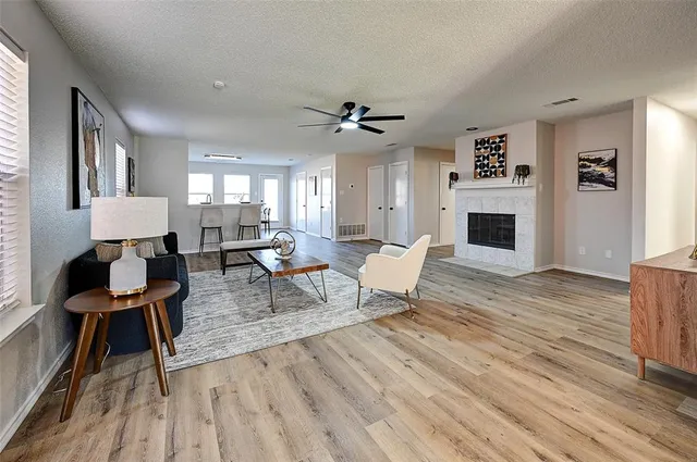a living room with furniture a fireplace and a table