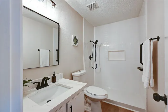 a bathroom with a sink toilet and shower
