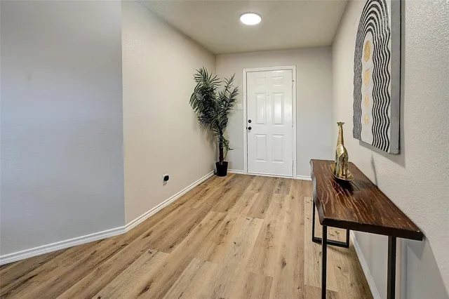 a view of a room with wooden floor and stairs