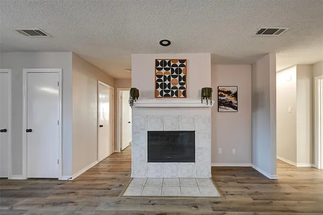 a living room with a fireplace and a wooden floor