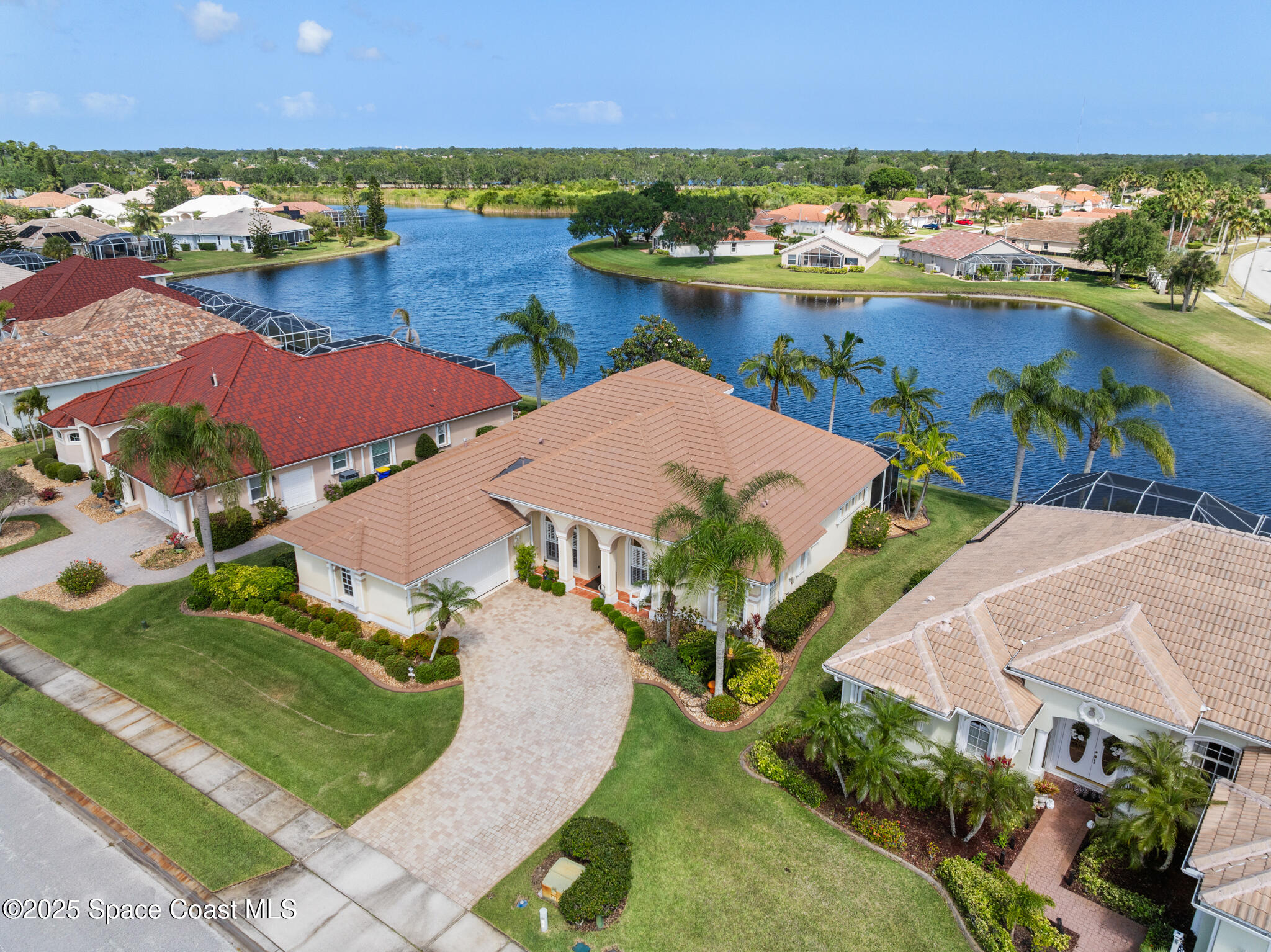 an aerial view of residential houses with outdoor space and river