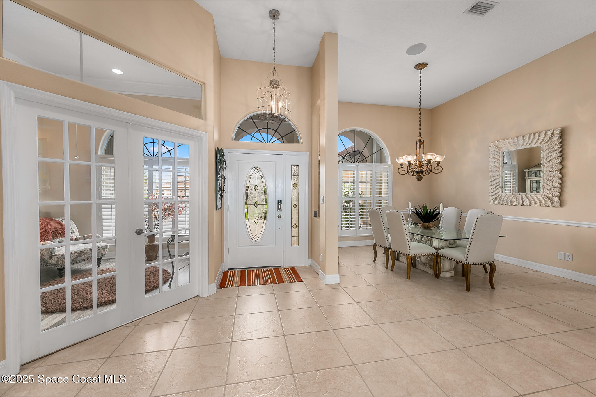 4336 Collingtree Drive Rockledge, FL 32955 - Photo 12 of 62 a living room with furniture a window and a chandelier
