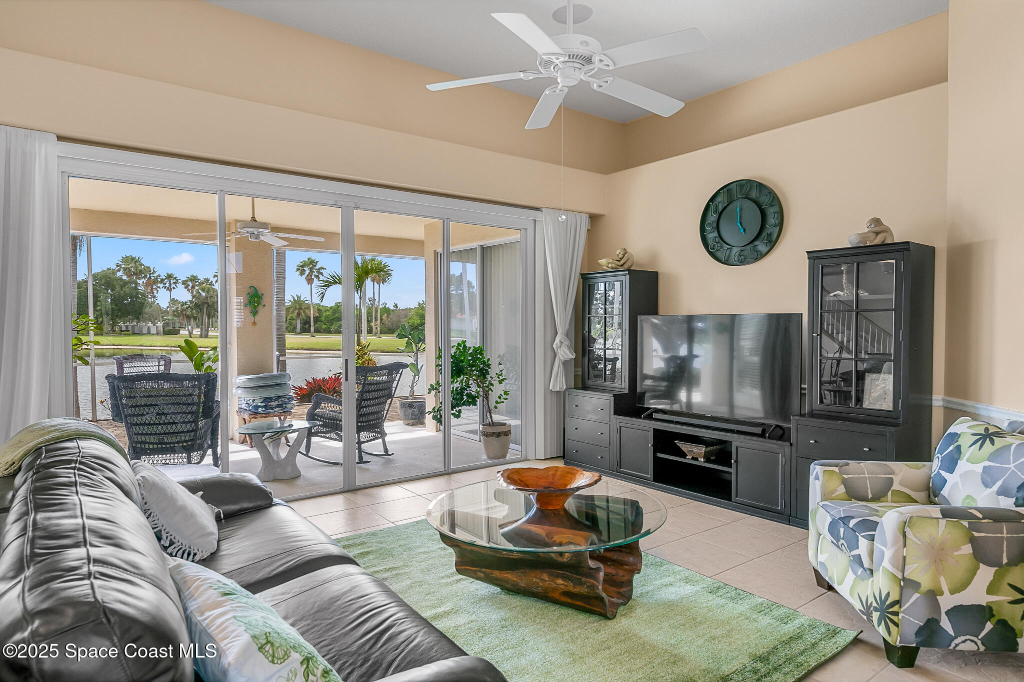 4336 Collingtree Drive Rockledge, FL 32955 - Photo 21 of 62 a living room with furniture a rug a fireplace and a large window