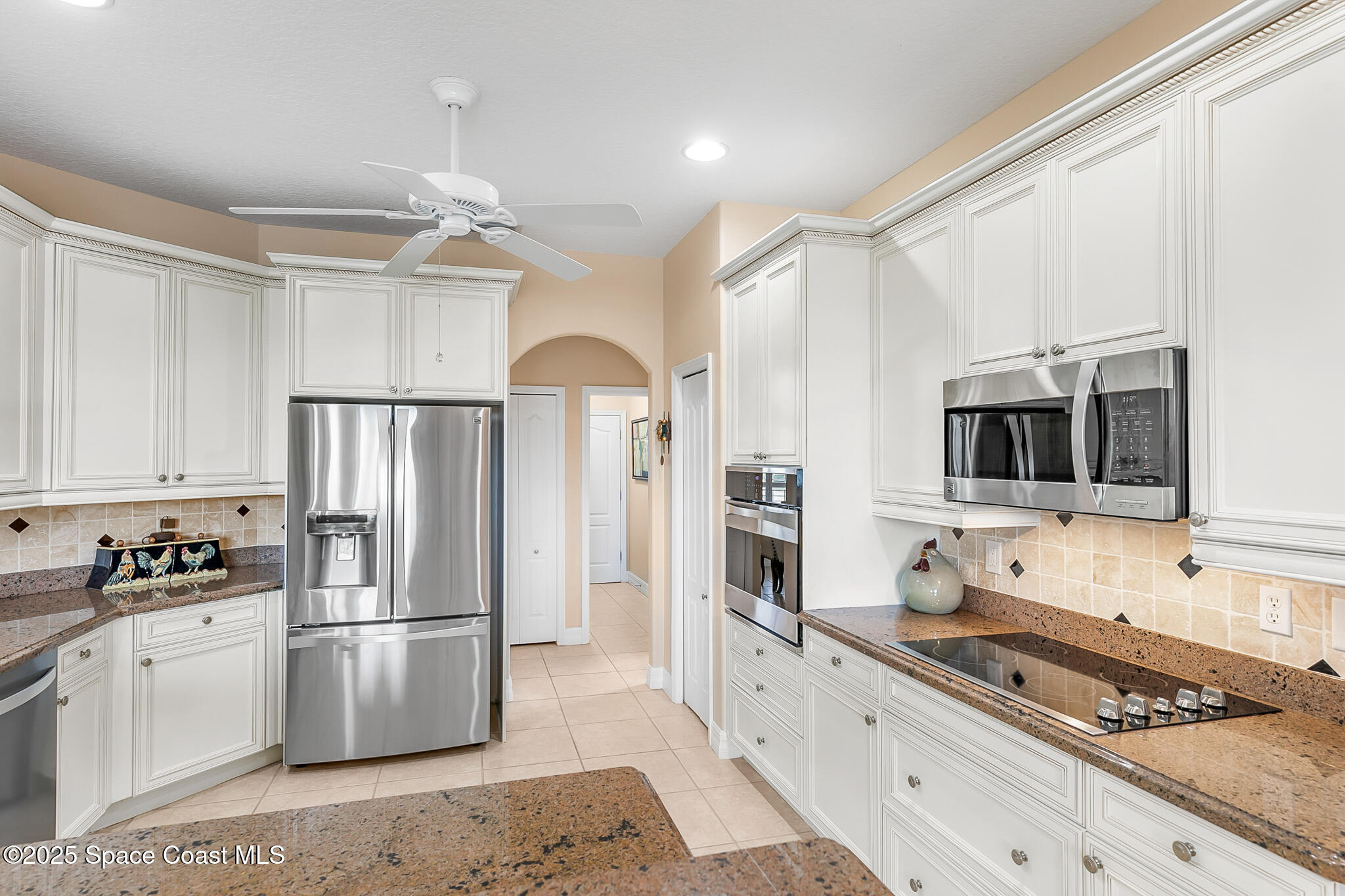4336 Collingtree Drive Rockledge, FL 32955 - Photo 38 of 62 a kitchen with stainless steel appliances a refrigerator sink and microwave
