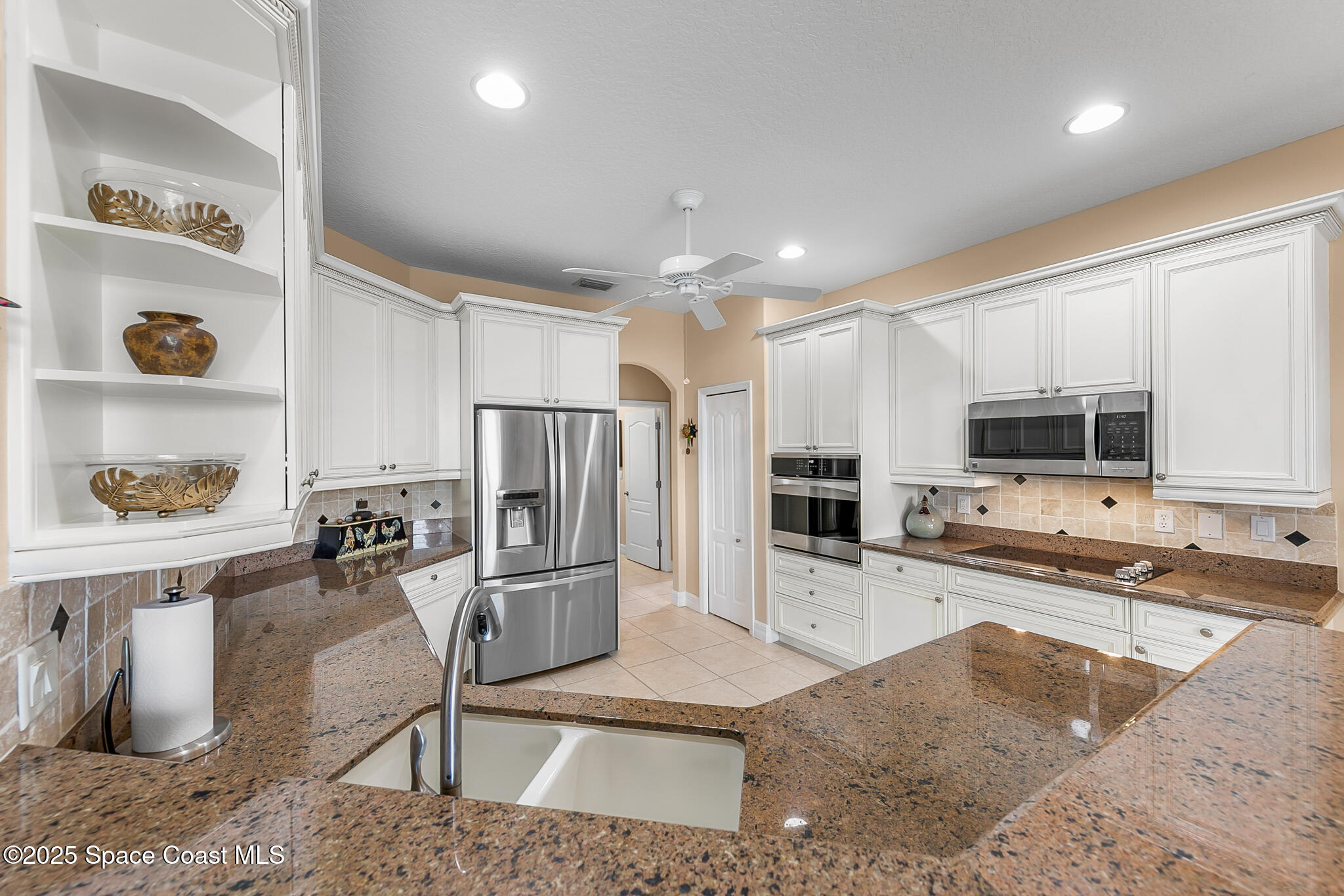 4336 Collingtree Drive Rockledge, FL 32955 - Photo 39 of 62 a kitchen with stainless steel appliances granite countertop a sink refrigerator and cabinets