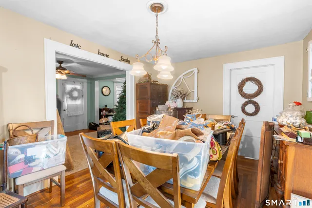 a view of a dining room with furniture and a chandelier