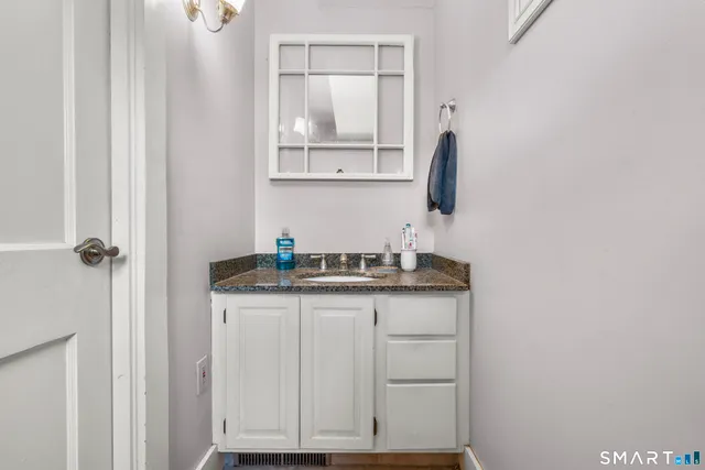 a kitchen with granite countertop a sink and cabinets