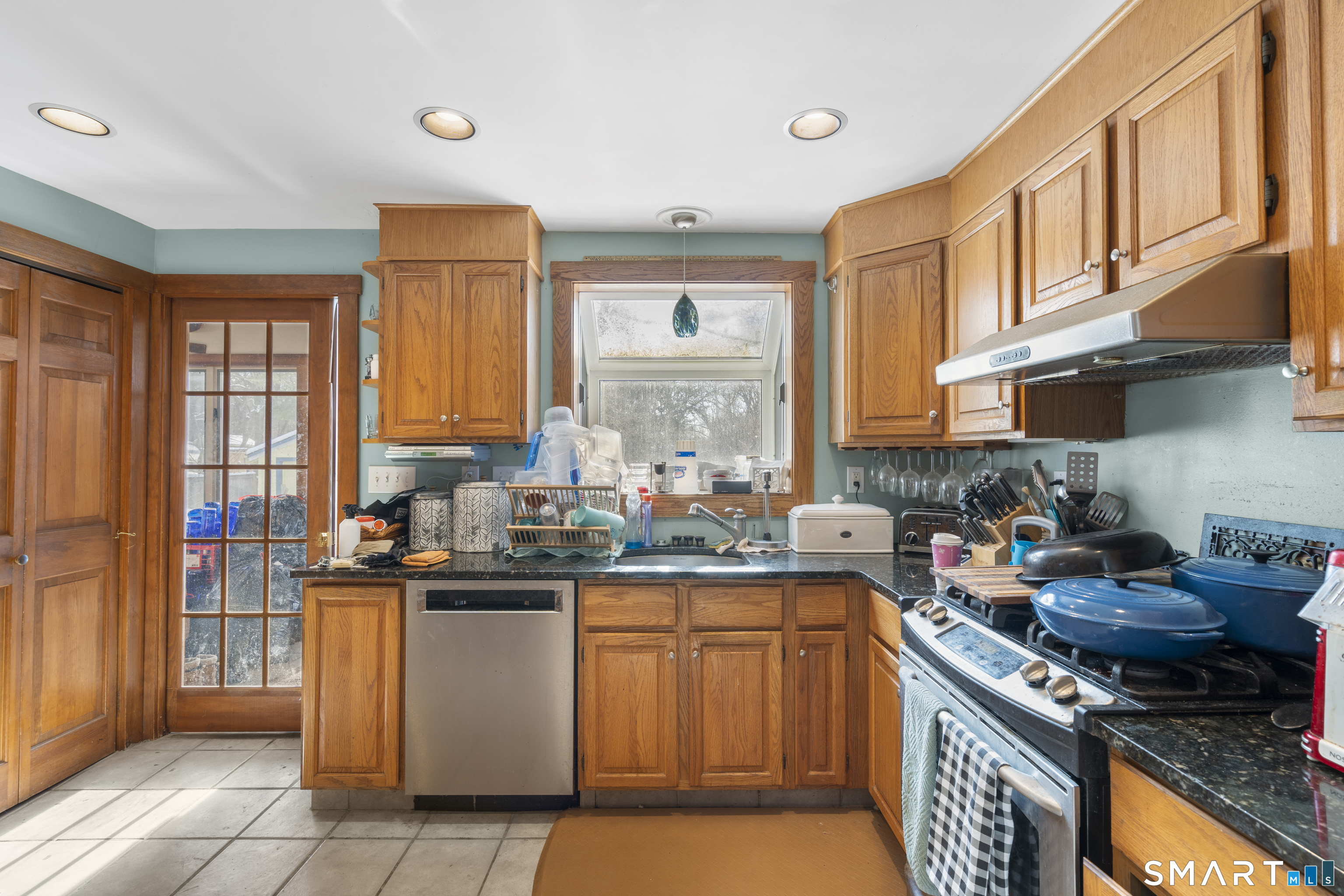 28 Reservoir Street Bethel, CT 06801 - Photo 4 of 40 a kitchen with stainless steel appliances granite countertop a stove a sink dishwasher and cabinets with wooden floor