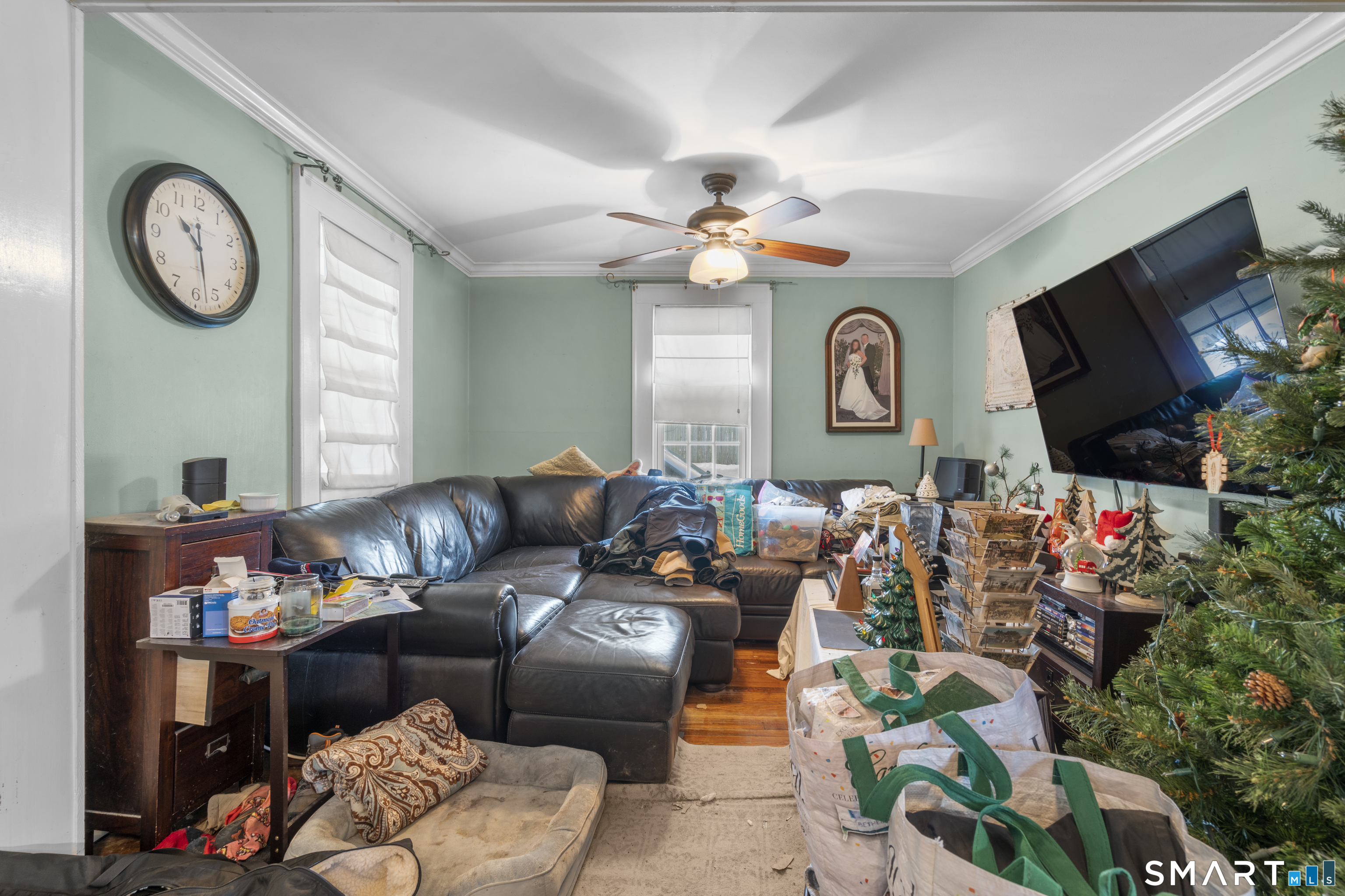 28 Reservoir Street Bethel, CT 06801 - Photo 7 of 40 a living room with furniture a clock and a flat screen tv