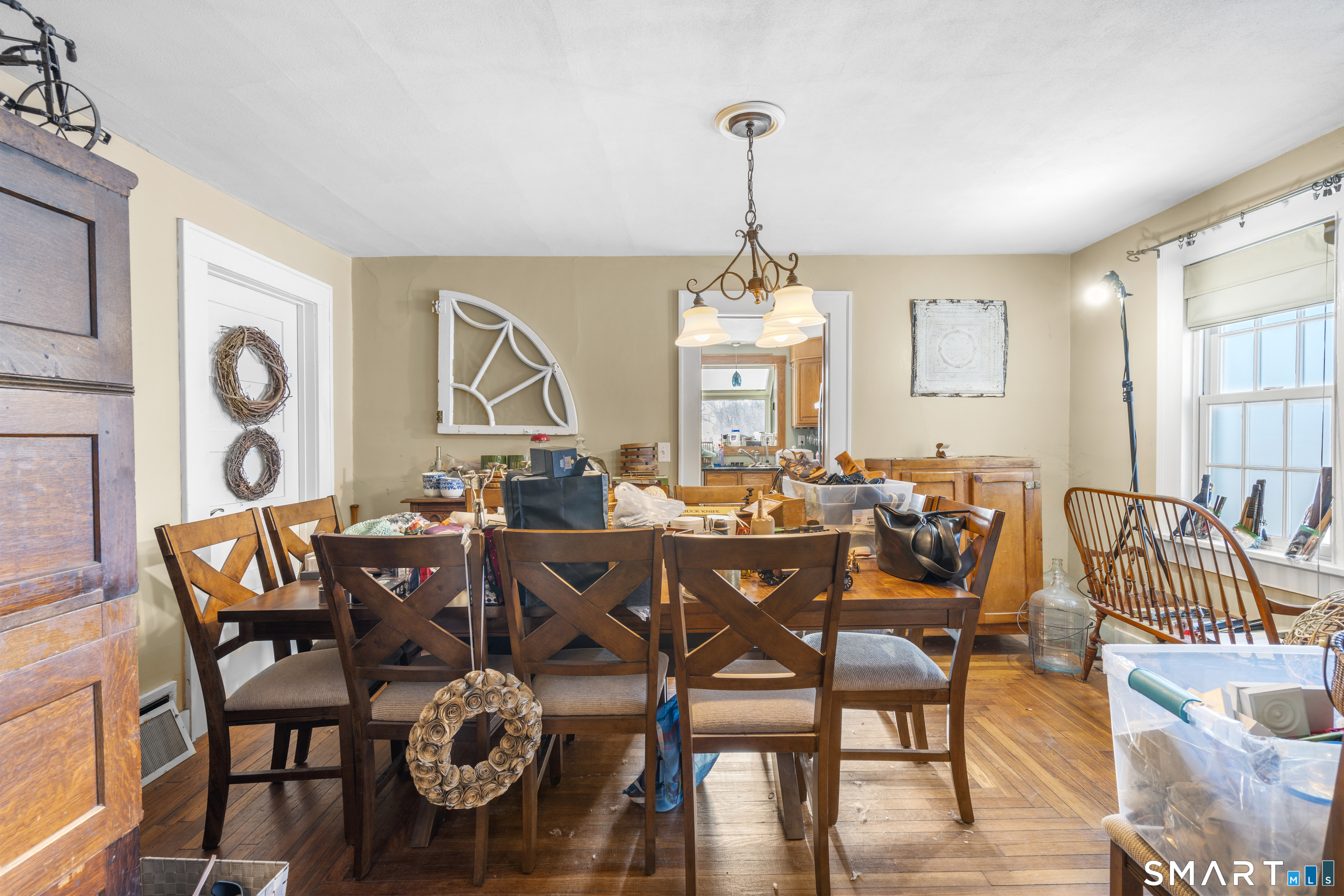 28 Reservoir Street Bethel, CT 06801 - Photo 9 of 40 a view of a dining room and livingroom with furniture wooden floor a chandelier
