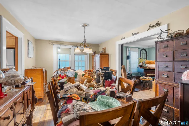 a view of a dining room with furniture and chandelier